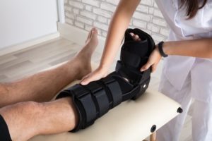 Nurse holding a patient's ankle support boot