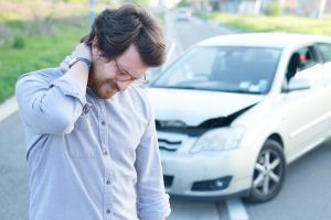 Man suffering from whiplash after a car accident
