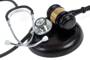A stethoscope and a gavel alongside each other. 