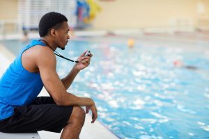 A life guard watches for swimming accidents at a local swimming pool