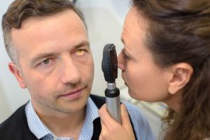 An ophthalmologist examines a mans eye. 