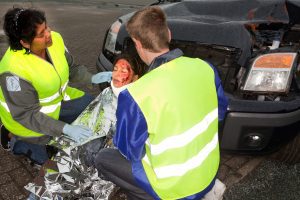 Two paramedics attend the scene of an accident. 