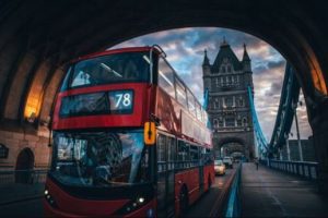 A double decker bus crossing Tower Bridge in London