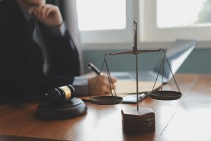 A solicitor at a desk making notes on an e-scooter accident claim. 