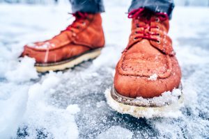 A person walks on icy ground.