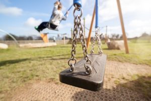 IMAGE OF A CHILD'S SWING AND PLAYGROUND EQUIPMENT