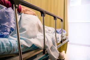 A woman lays on a hospital bed.