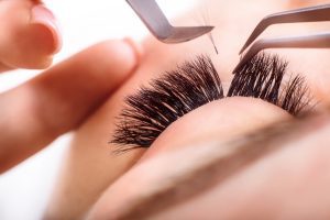 CLOSE UP OF SOMEONE HAVING SEMI PERMANENT EYELASH TREATMENT