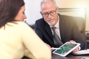 PERSONAL INJURY SOLICITOR DISCUSSING BEAUTY TREATMENT CLAIMS WITH HIS CLIENT