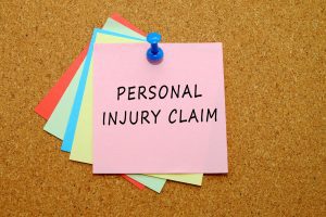 POST IT NOTES ON A CORK BOARD THAT READ 'PERSONAL INJURY CLAIM'