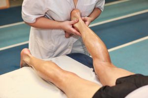 A masseuse massages a person. 