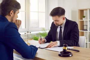 SOLICITOR EXPLAINING FOOD POISONING COMPENSATION CLAIMS TO HIS CLIENT